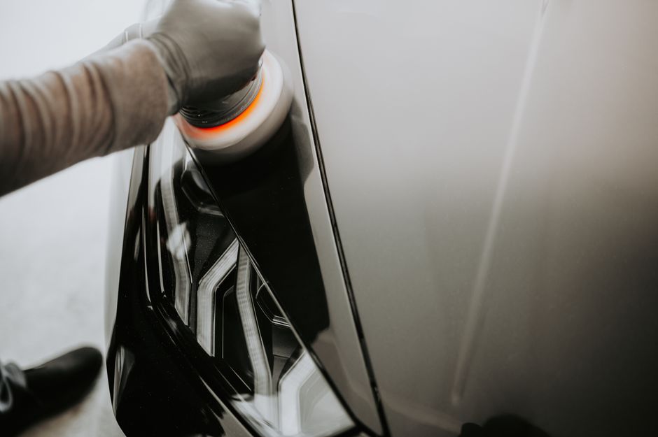 Professional applying ceramic coating to car paint